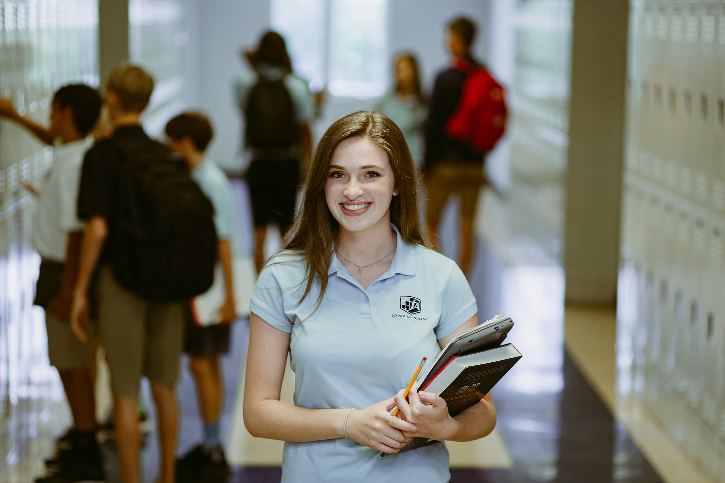 Student at Foundation Academy in school hallway