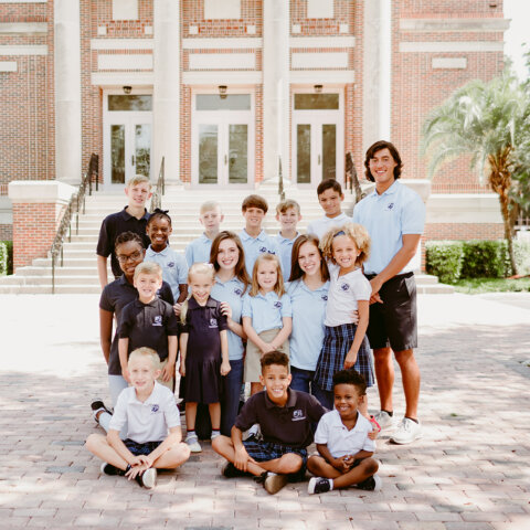 Foundation Academy Students Posing for Photo Outside on Shaded Part of the Sidewalk