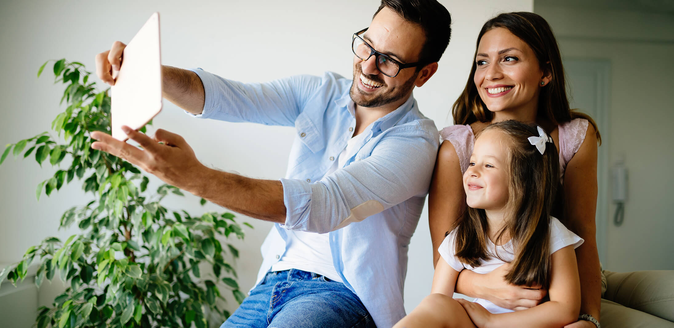 happy family taking selfie in their house ZRYDA45