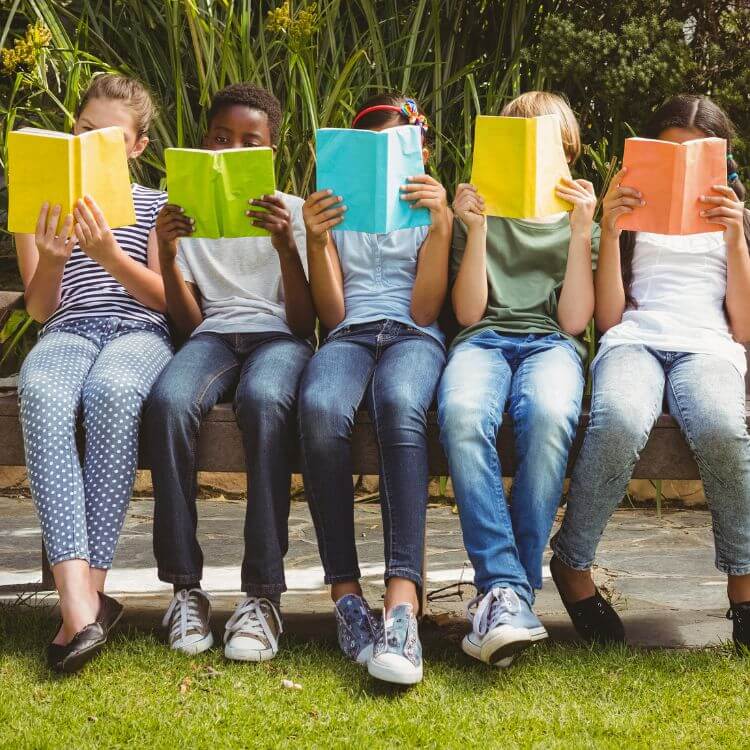 kids reading books on bench